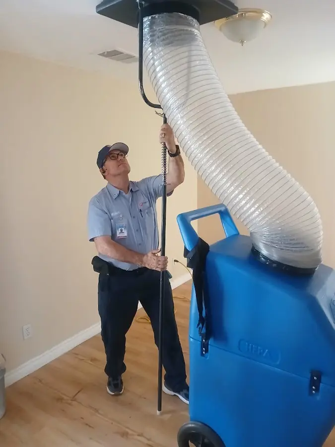 Furnace Tune-Up technician using HEPA equipment in Reedurban
